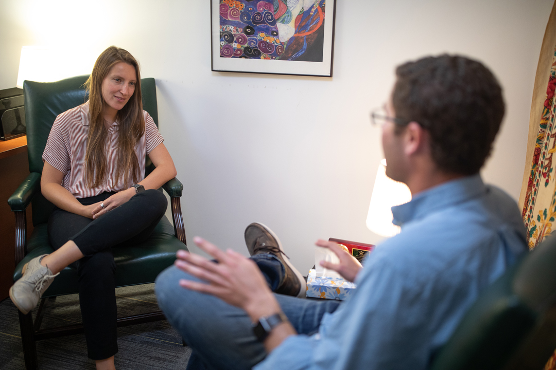 Two PsyD students interacting in an office setting