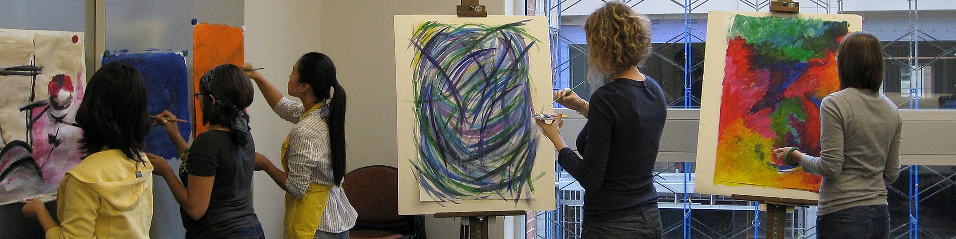 Students painting in an art therapy classroom